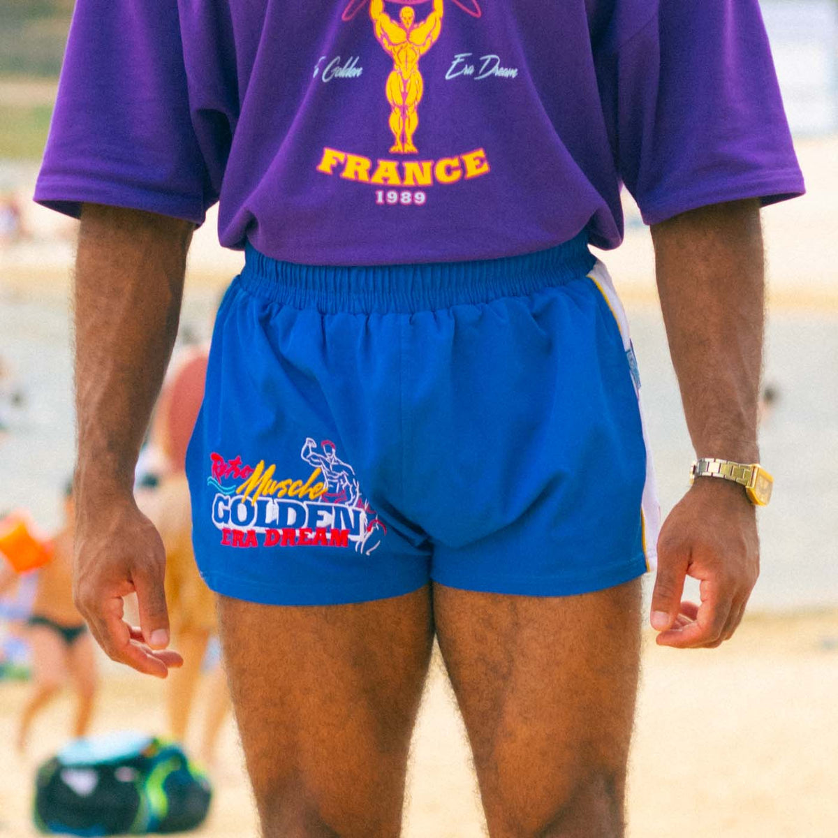 Golden Era Dream board short worn in a Purple World beach scene